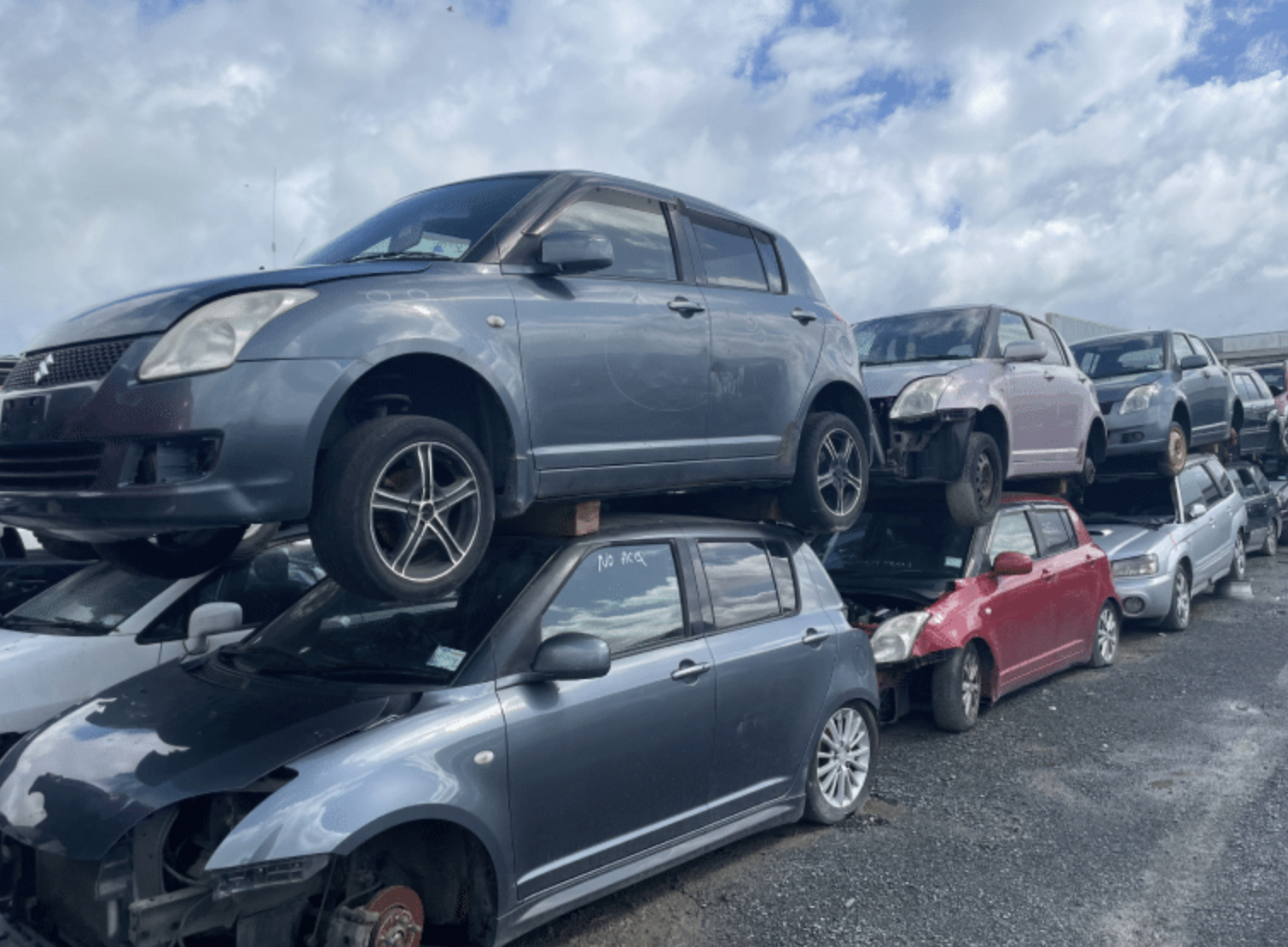 Scrap cars stacked in a Hamilton auto wrecking yard
